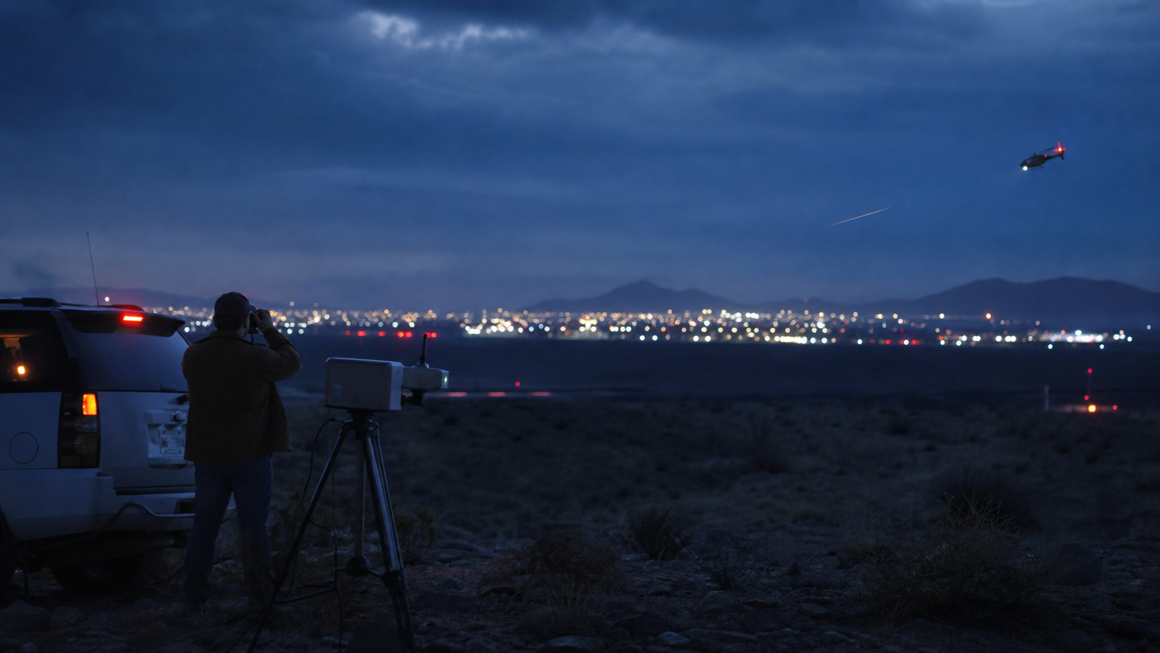 AI-generated editorial image of a blue-hour desert border landscape near El Paso and Santa Teresa with distant city lights, a helicopter, and observation equipment.