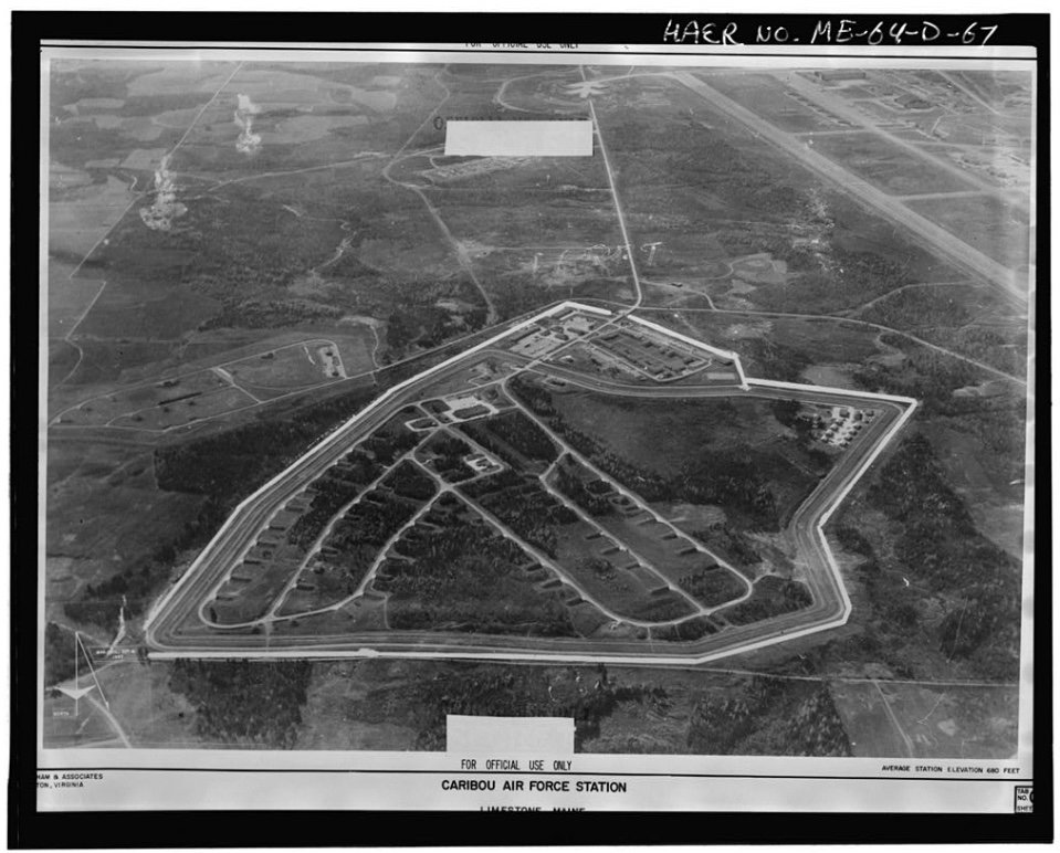 A 1967 USAF aerial photograph of the Loring Air Force Base weapons-storage area near Limestone, Maine, known informally as the 'Christmas Tree' for the radiating pattern of igloos. The triangular fenced perimeter encloses three concentric rings of hardened aircraft shelters and weapons-storage igloos. The main base runway runs diagonally across the upper-left of the frame. The image is stamped 'FOR OFFICIAL USE ONLY' and is filed under HAER No. ME-64-D-67.